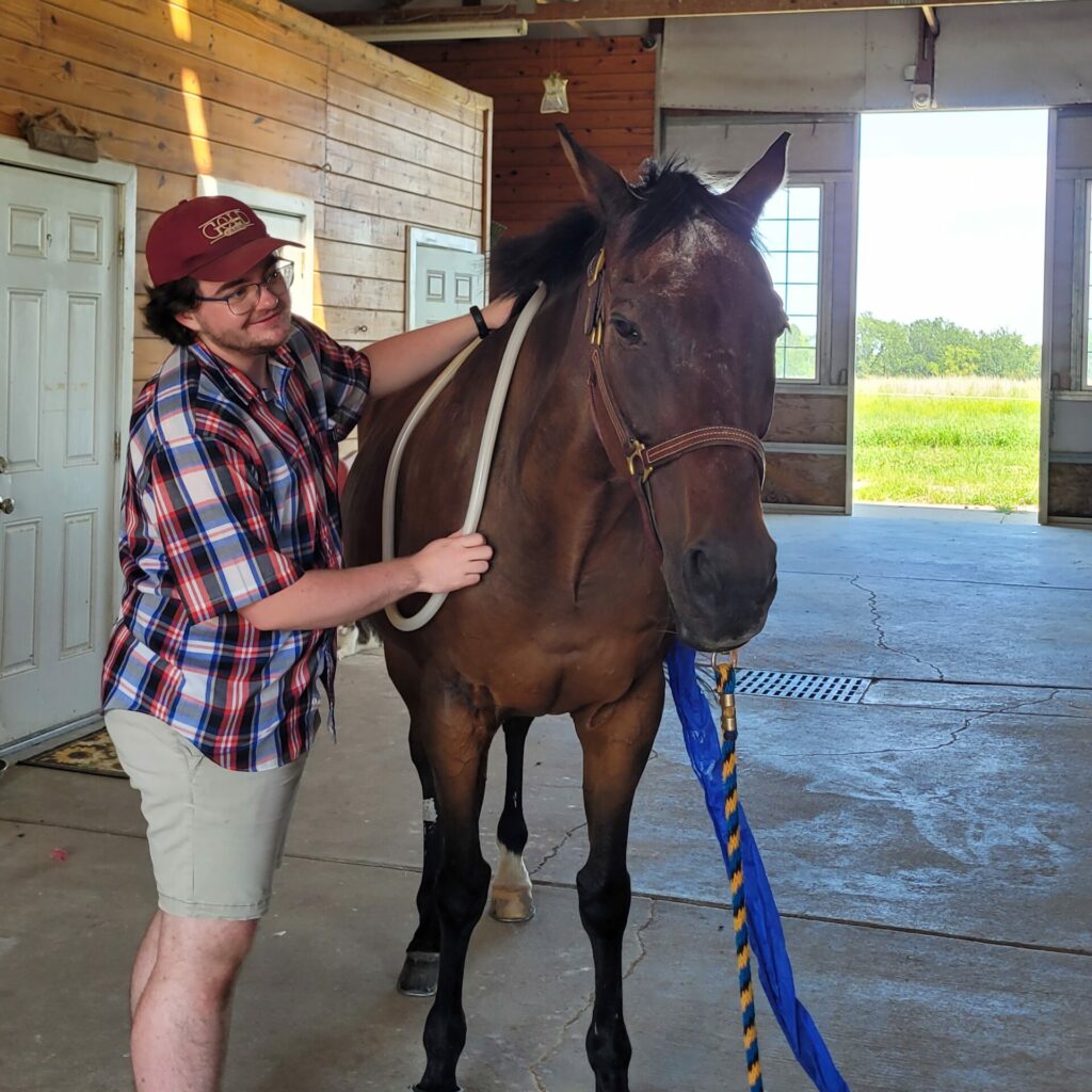 Max holding magnawave loops over a bay horse
